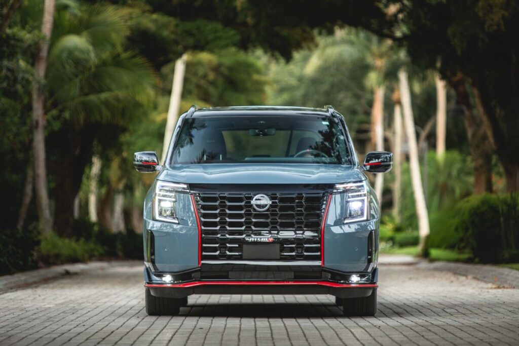 2026 Nissan Armada Nismo front end on a tree lined street